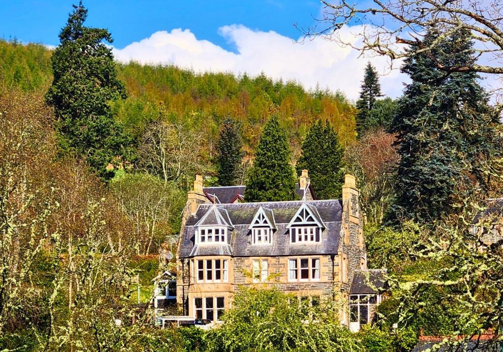 an old house on the side of a hill at The Retreat Hotel in Strathpeffer