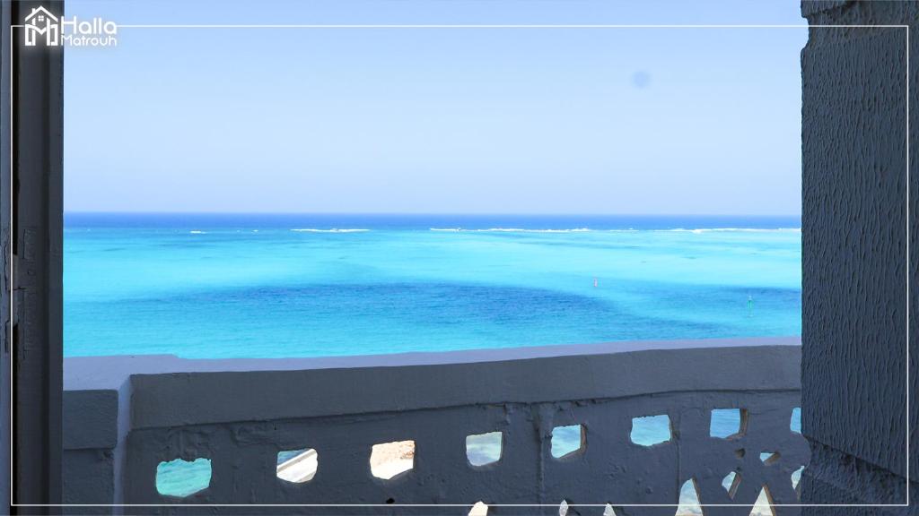 a view of the ocean from a balcony at Halla Matrouh Sea View in Marsa Matruh