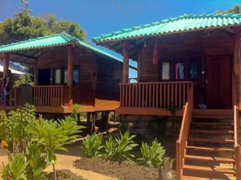 a wooden house with a staircase leading to it at Ocean View (Cabana & Guest House) in Arugam Bay