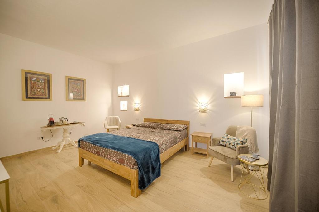 a bedroom with a bed and a table and a chair at Cozy guest house Downtown in Olbia