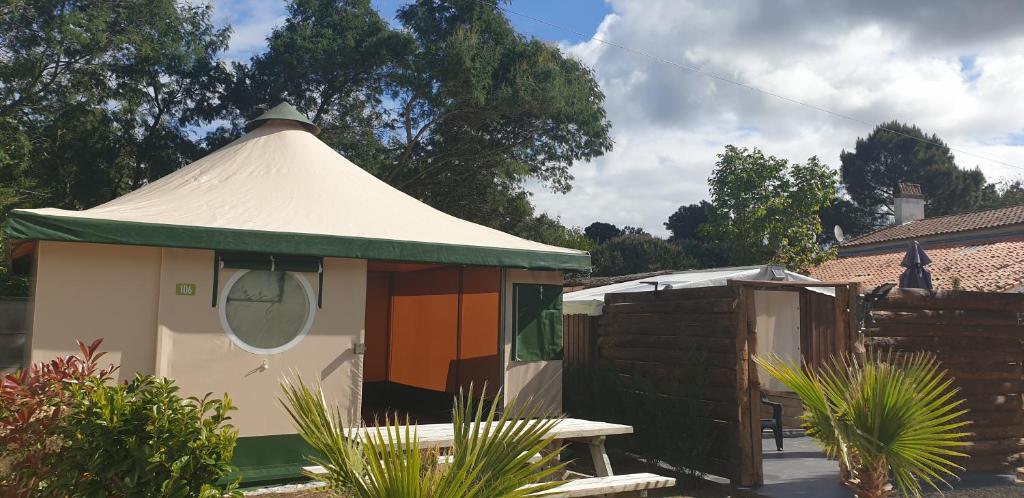 a gazebo with a tent in a garden at Tente lodge et logement atypique pour 2 à 6 pers aux Mathes La Palmyre in Les Mathes