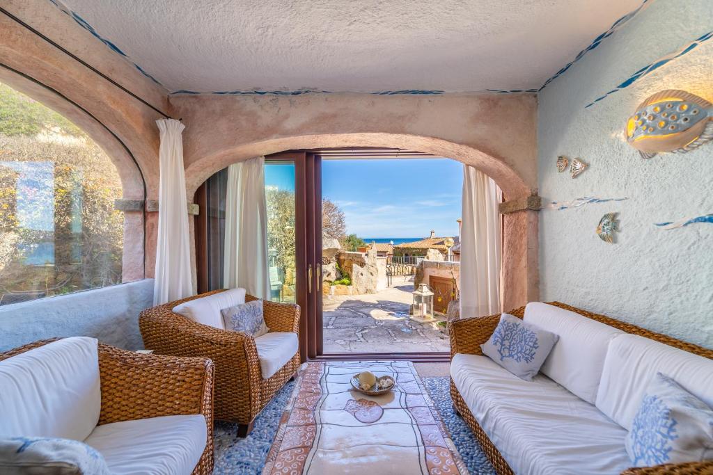 a living room with two couches and a balcony at Villa Ilda in Cannigione