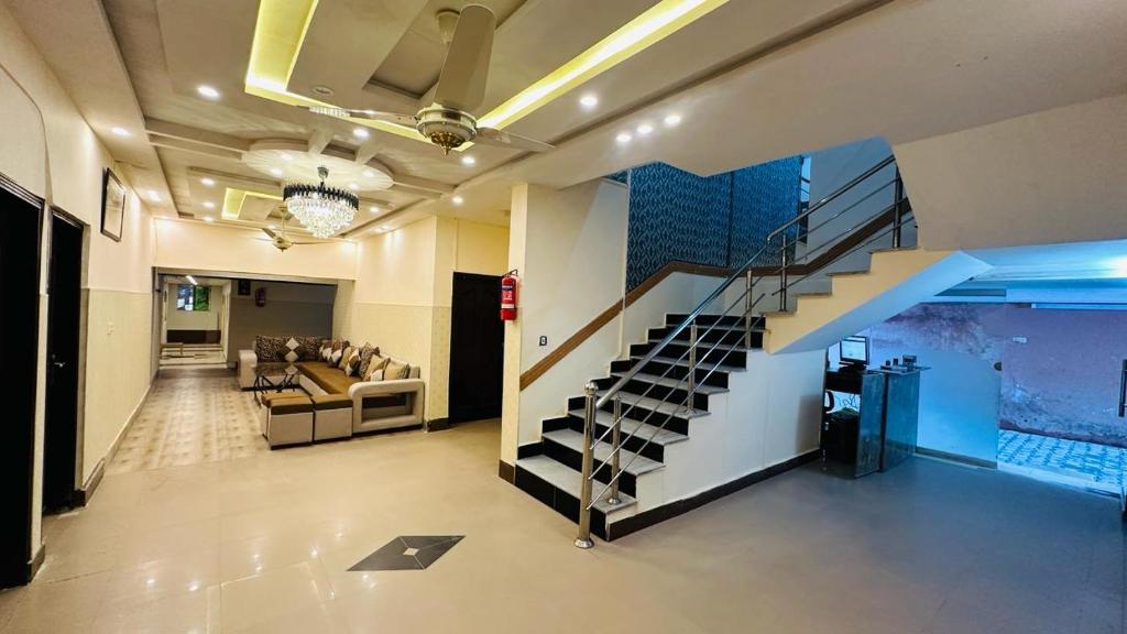 a living room with a staircase in a house at Amyl's Garden in Islamabad