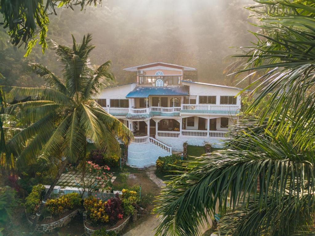 an aerial view of a house with a palm tree at Sea Esta Resort & Cafe in Kashid