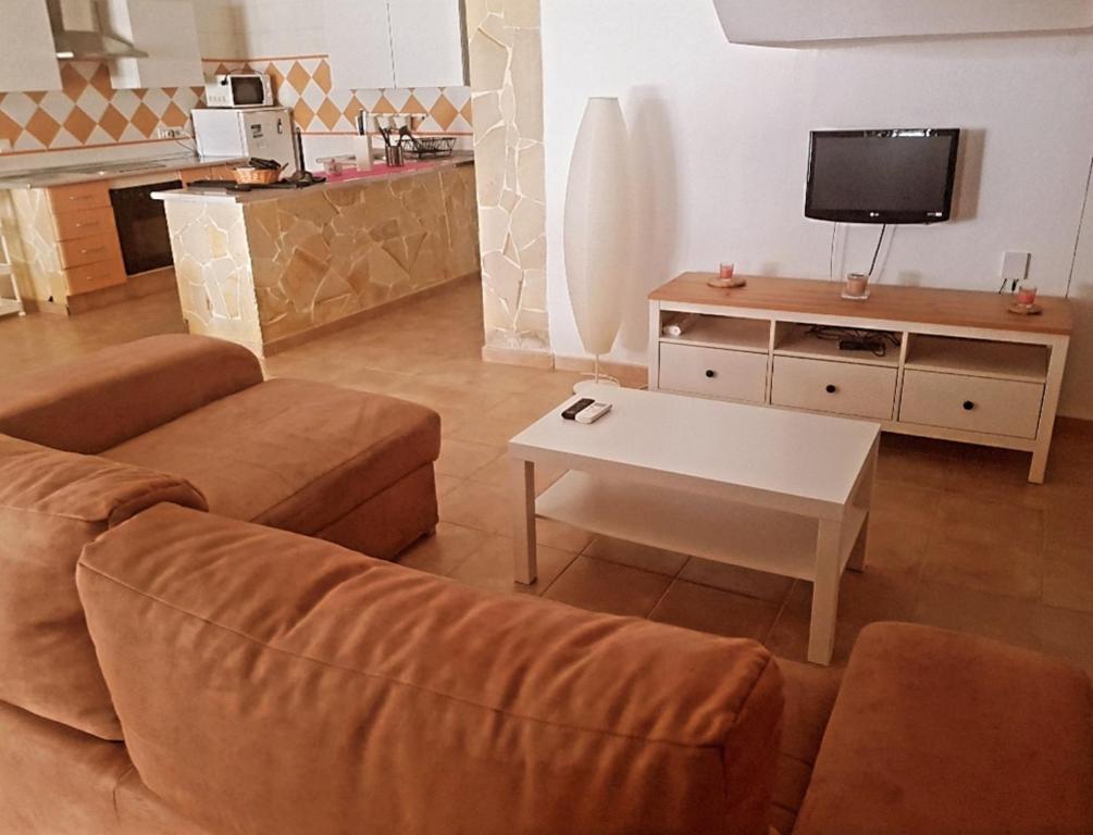 a living room with a couch and a coffee table at Apartamento Daniella Nerja in Nerja