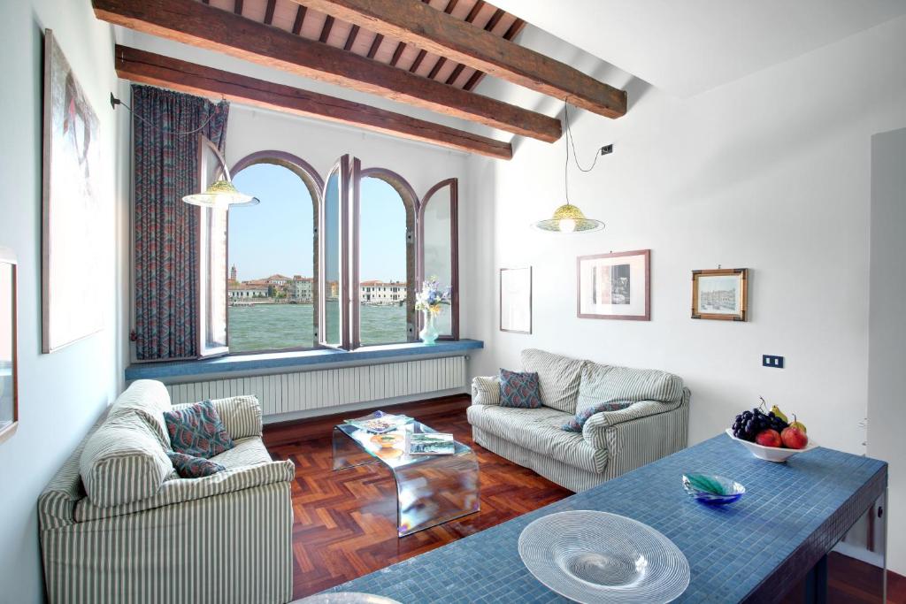 a living room with two couches and a table at Giudecca in Venice