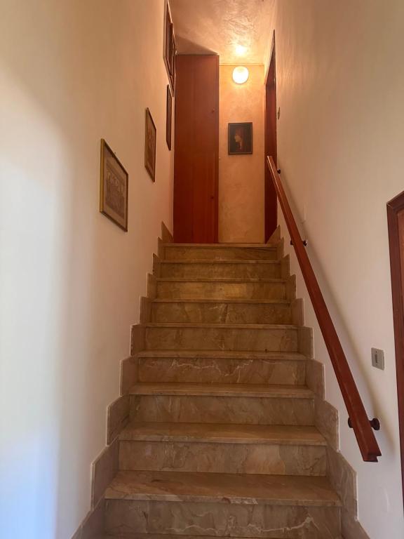 a staircase in a house with a wooden door at Vila Romaneasca in Corbola