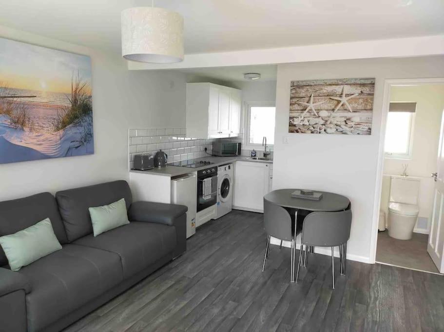 a living room with a couch and a table at California Sands - 2 x Modern Two Double Bedroom Chalets - short stroll to the beach - nr Great Yarmouth & Norfolk Broads in Scratby