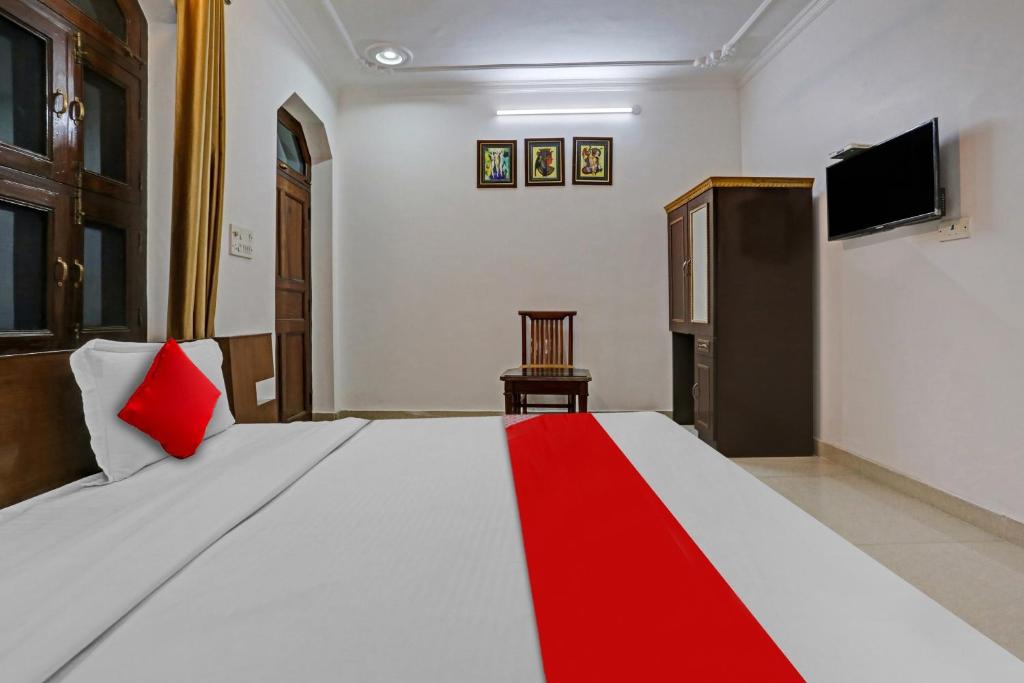 a bedroom with a large bed and a television at OYO Flagship Premium rooms in New Delhi