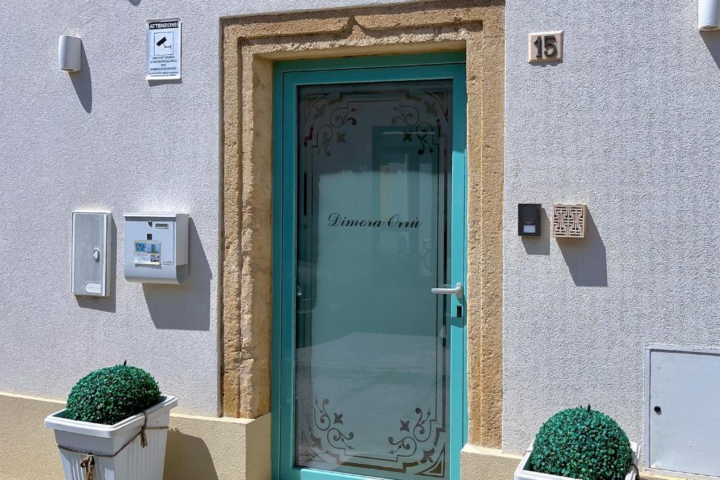 una porta a vetri sul lato di un edificio di B&B Dimora Orrù a Càbras
