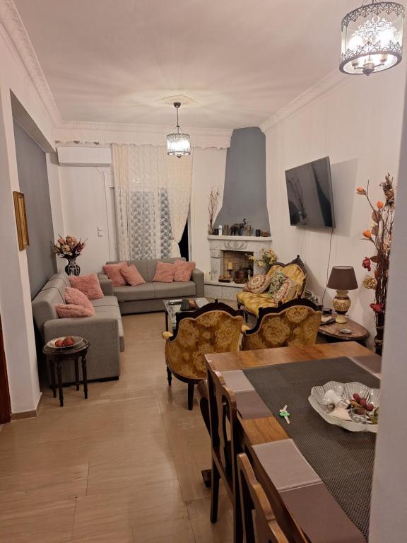 a living room with a couch and a table at Valerias house in Aígio