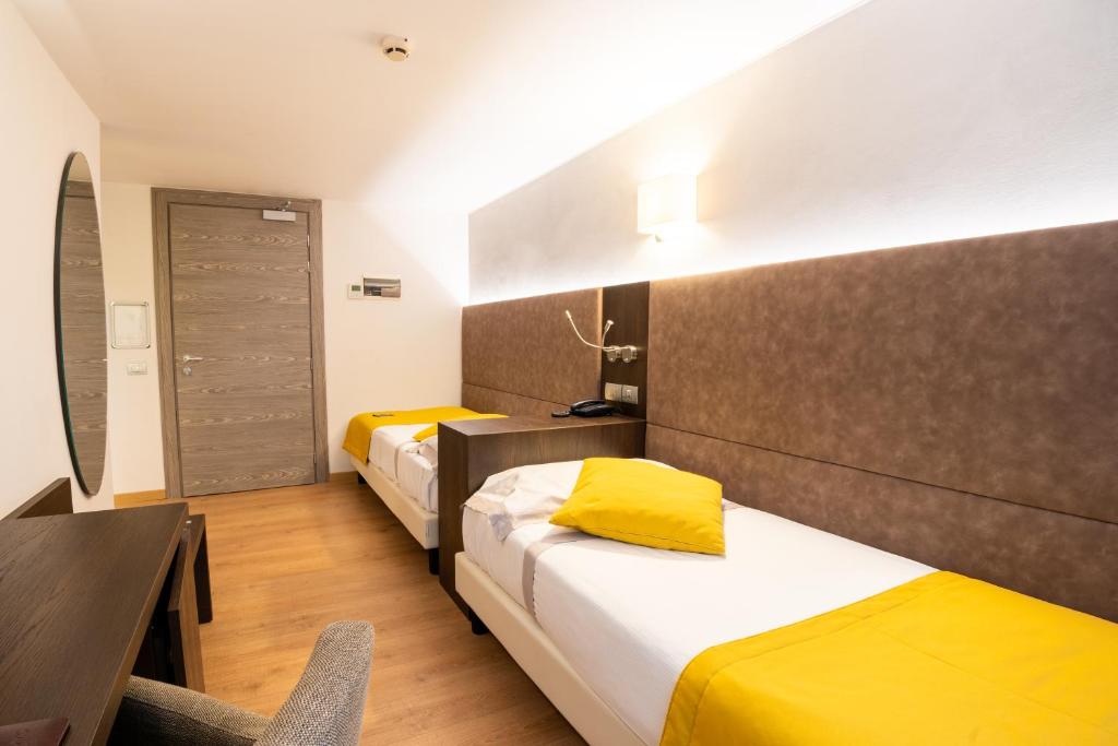 Una cama o camas en una habitación de Hotel Como