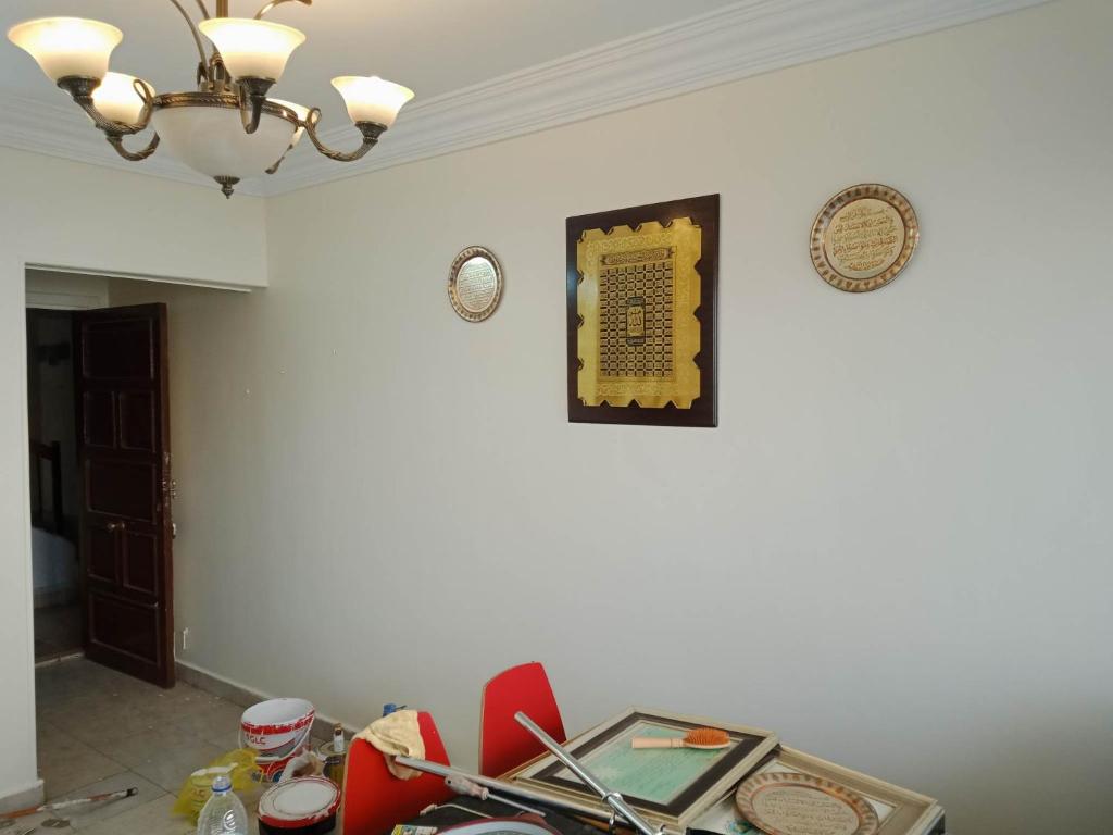 a dining room with a table and red chairs at مدينه نصر in Cairo