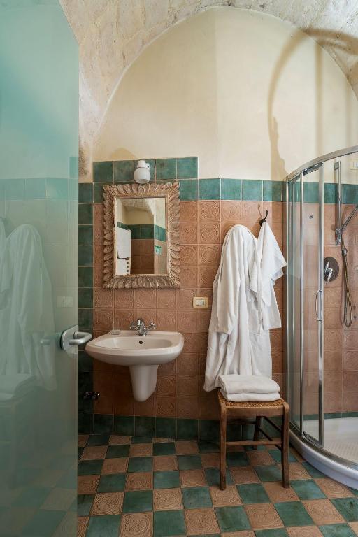 a bathroom with a sink and a shower at Locanda Di San Martino Hotel & Thermae Romanae in Matera