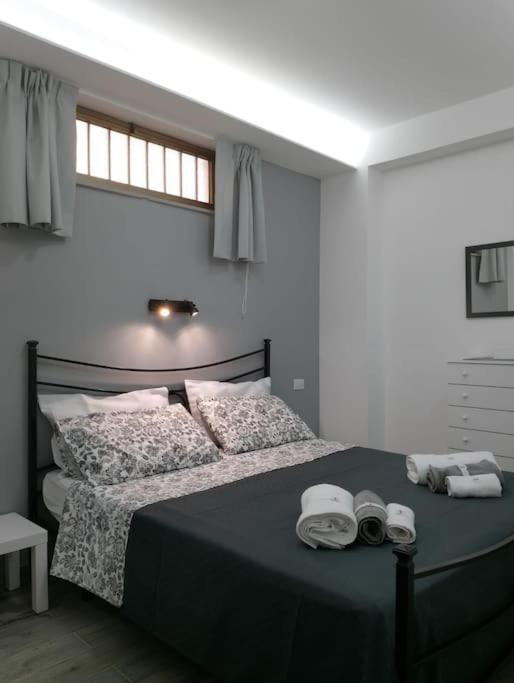 a bedroom with a bed with towels on it at Maria's guesthouse in Letojanni
