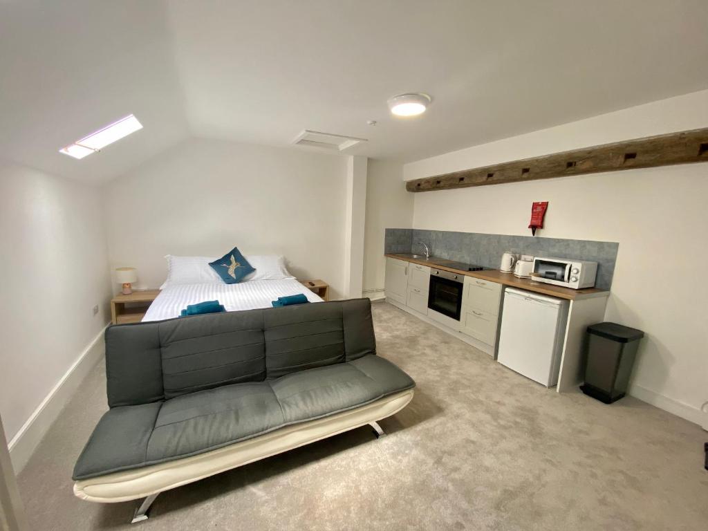 a living room with a couch and a microwave at JP Short Stays in Upton upon Severn