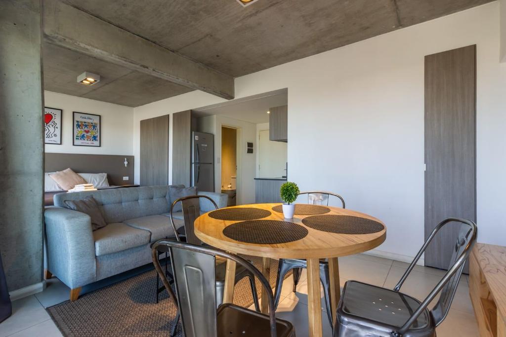 a living room with a table and chairs and a couch at Loft Elegante a 5 Minutos de Puerto Madero 6B in Buenos Aires