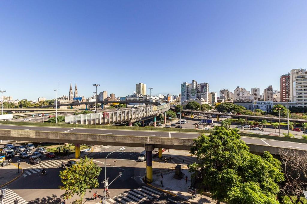 a city with a bridge and a freeway at Loft Elegante a 5 Minutos de Puerto Madero 6B in Buenos Aires