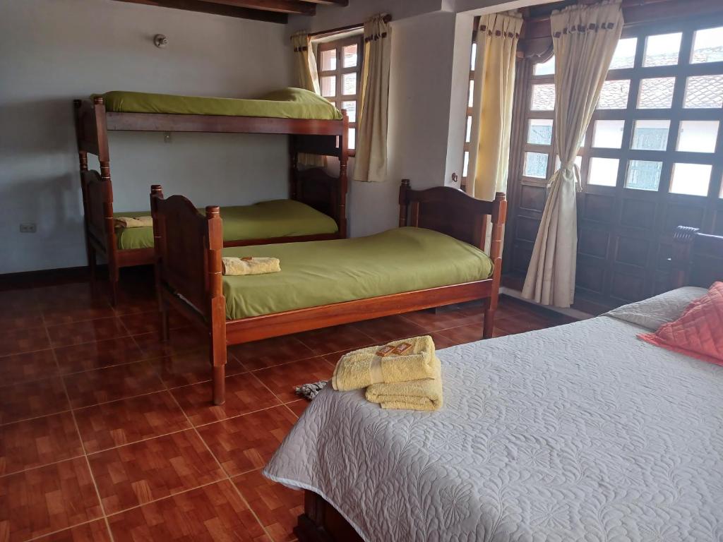 Postel nebo postele na pokoji v ubytování Chez Alicia Hostal
