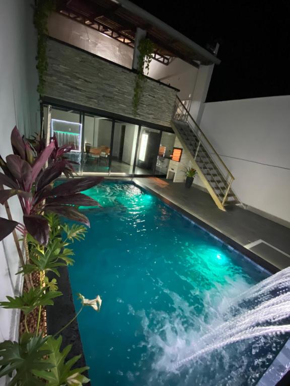 a swimming pool in the middle of a house at Hospedaria Flamboyant in Goiânia
