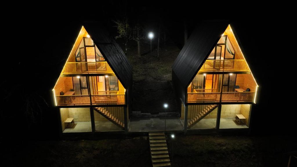 a large building with two large windows at night at KALOHOUSE in Dandalo