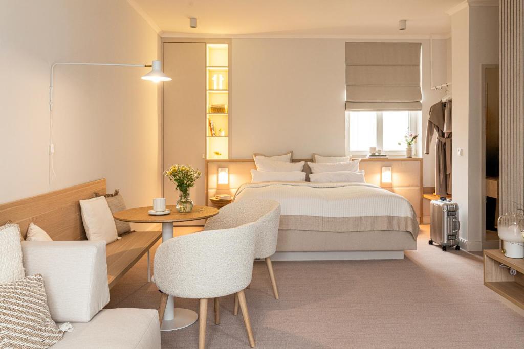 a bedroom with a bed and a table and chairs at Villa Astoria - Kühlungsborn in Kühlungsborn