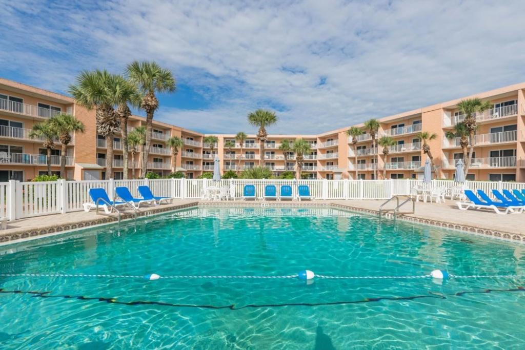 a swimming pool with chairs and a resort at St Augustine Beach Tennis 405 New in Saint Augustine
