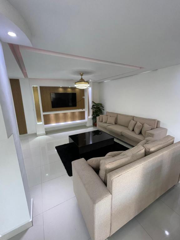 sala de estar con sofá y mesa en Villa 1, en Santo Domingo