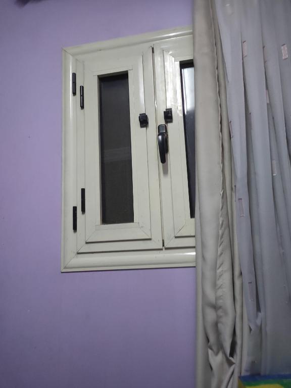 a mirror in a bathroom with a window at Egypt valy in Kafr Şaqr