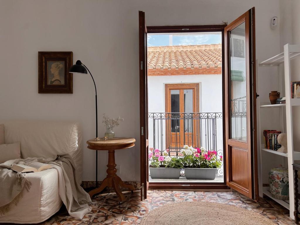 a living room with a door open to a balcony at Casa Barman Casco Antiguo Y Vistas Al Mar in Altea