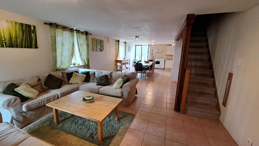 a living room with a couch and a table at Les Bigoussies in Ribérac