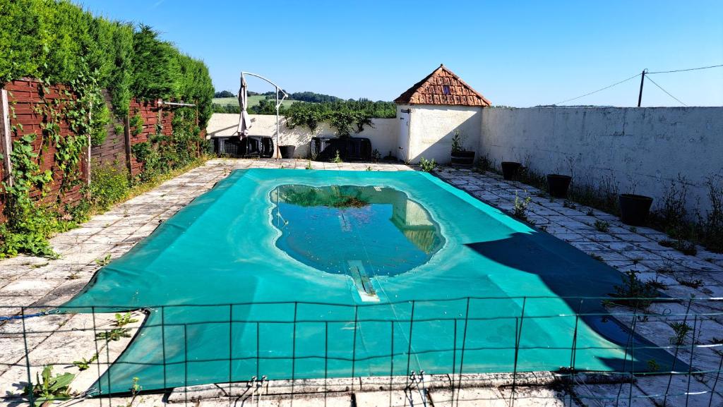 a swimming pool in the middle of a yard at Les Bigoussies in Ribérac