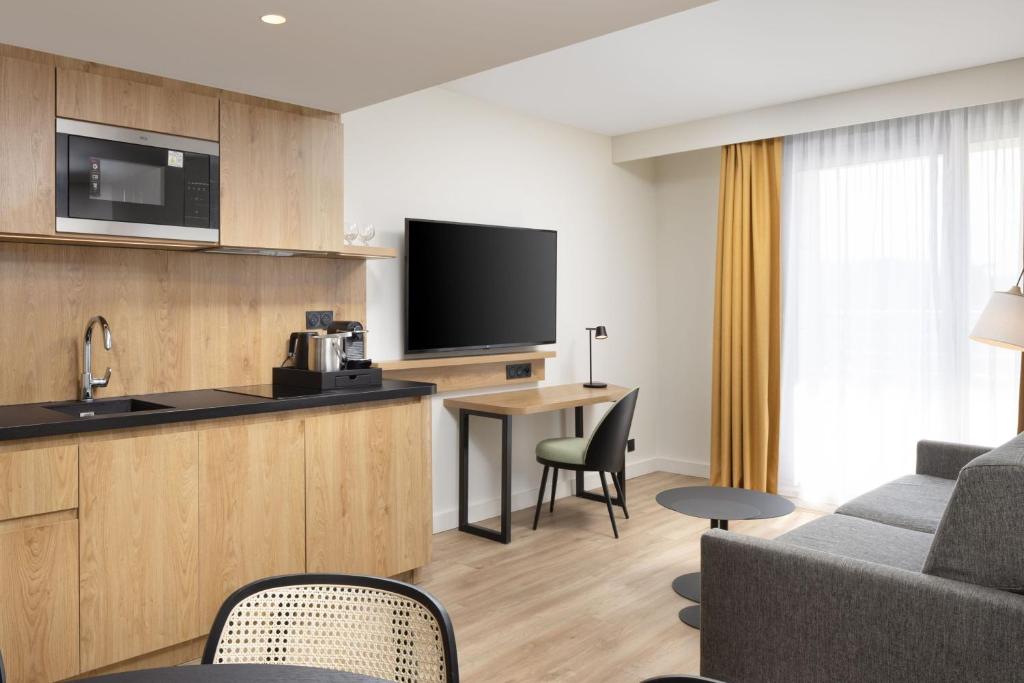 a hotel room with a kitchen and a living room at Residence Inn by Marriott Paris Didot Montparnasse in Paris