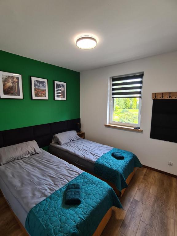 Postel nebo postele na pokoji v ubytování Noclegi przy Wiadukcie - Apartamenty