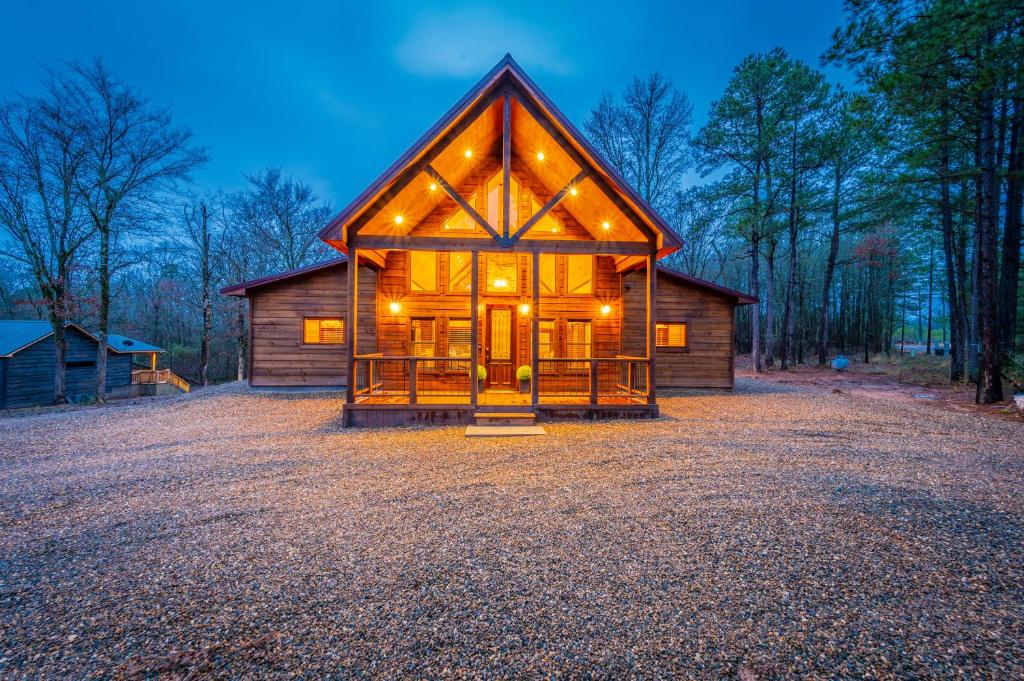 a small cabin with lights on the front of it at The Luxurious Blue Sky Lodge is EPIC! in Broken Bow