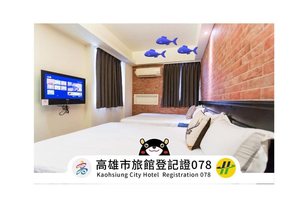a hotel room with a bed and a tv at Newrise Hotel in Kaohsiung