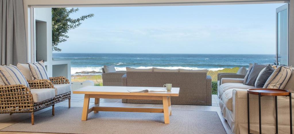 a living room with a view of the ocean at Seapearl Oceanfront Villa and Cottage in Hermanus