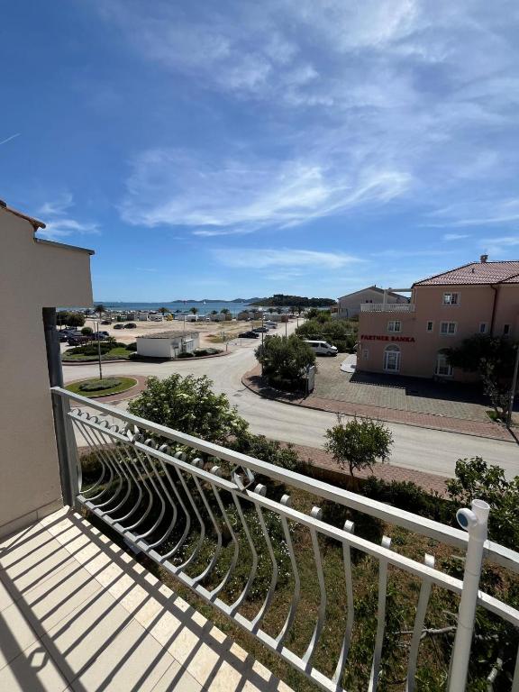 a balcony with a view of a street at Apartmani Šaldi in Pakoštane