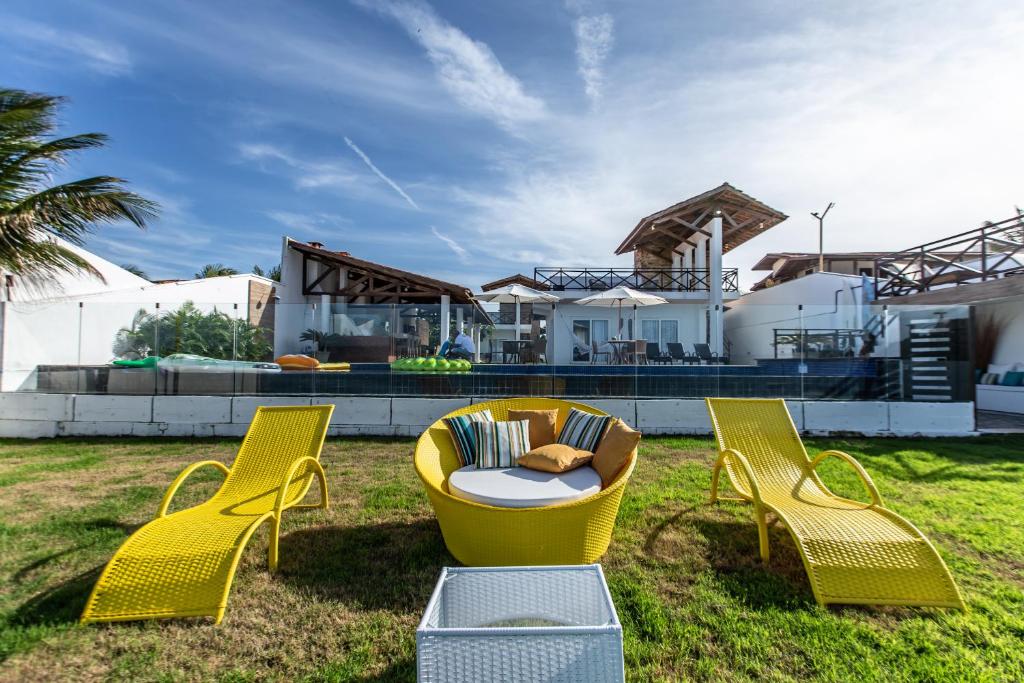 阿基拉斯的住宿－Casa La Baule，一组黄色椅子和一张桌子,放在院子里