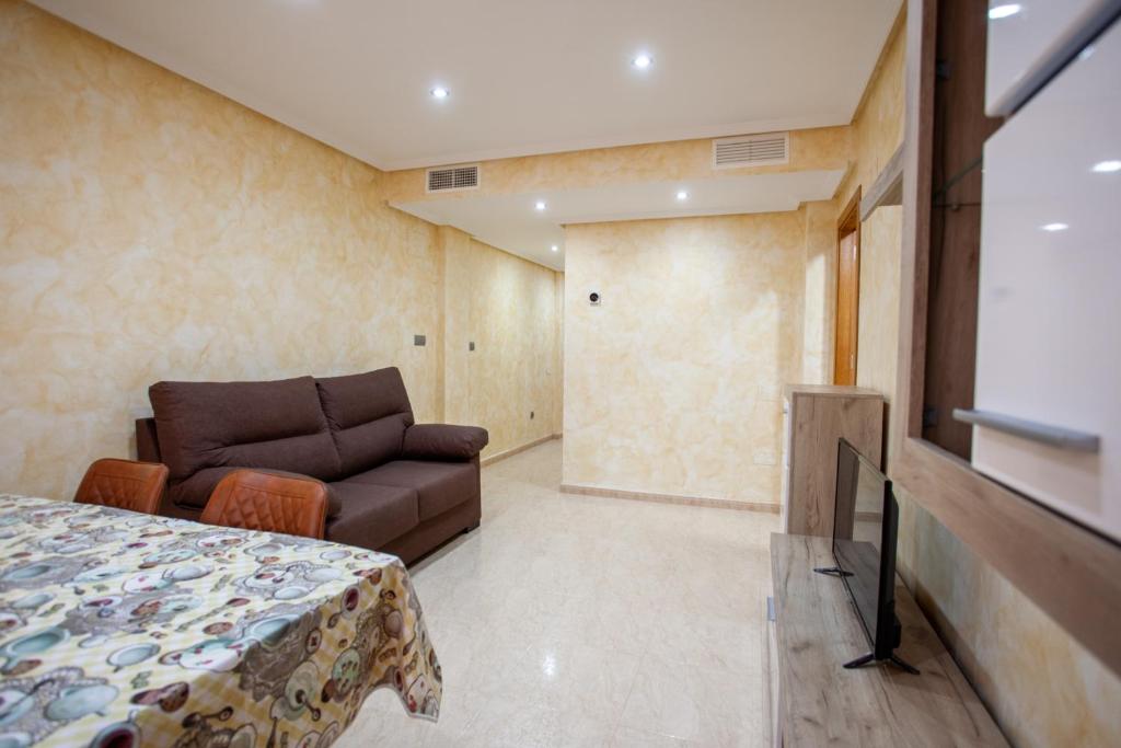 a bedroom with a bed and a couch in a room at Apartamento 1 Calle Tierno Galvan in Cox