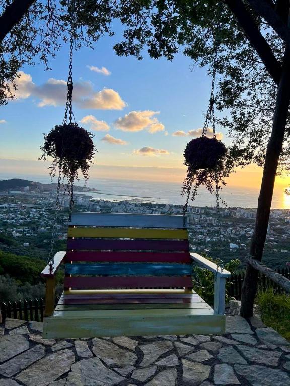 a swinging bench with a view of a city at Ranc Mujica in Bar