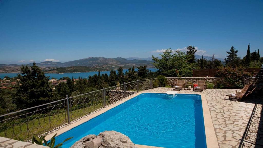 a swimming pool with a view of a lake at Theasis Villas in Lygia