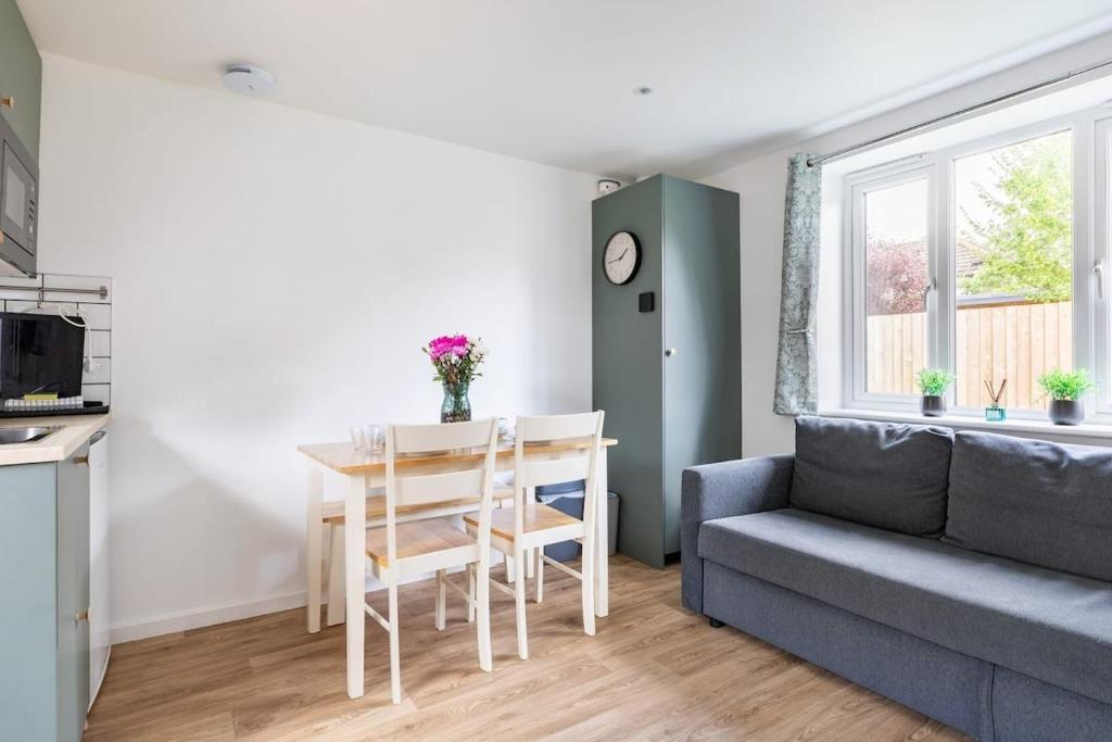 a living room with a couch and a table at Salisbury Garden Apartment in Salisbury