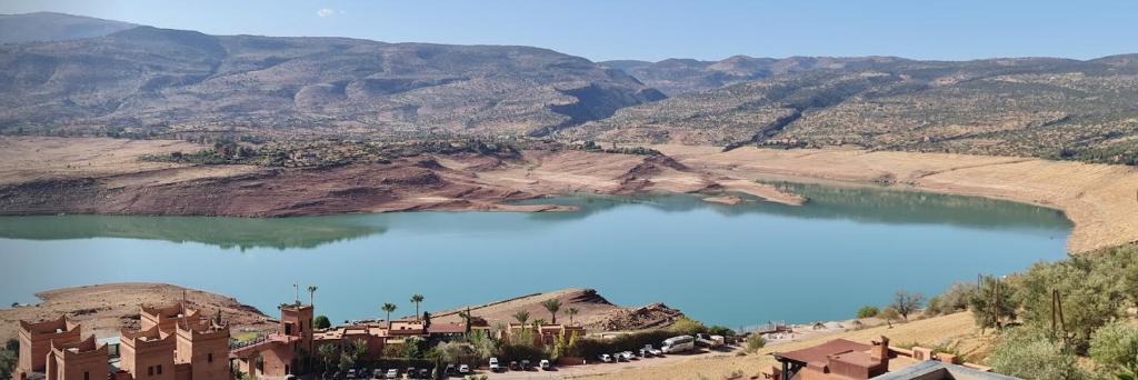 a view of a lake in the middle of a mountain at Familly House in Azilal