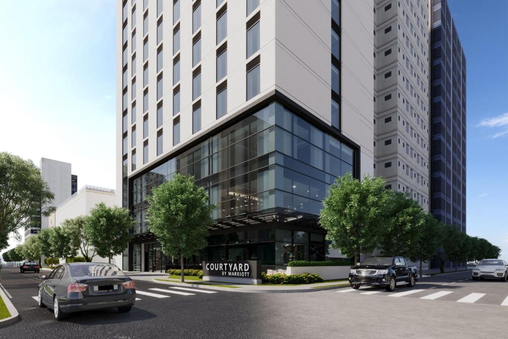 a rendering of the front of a building at Courtyard by Marriott Santo Domingo Piantini in Santo Domingo