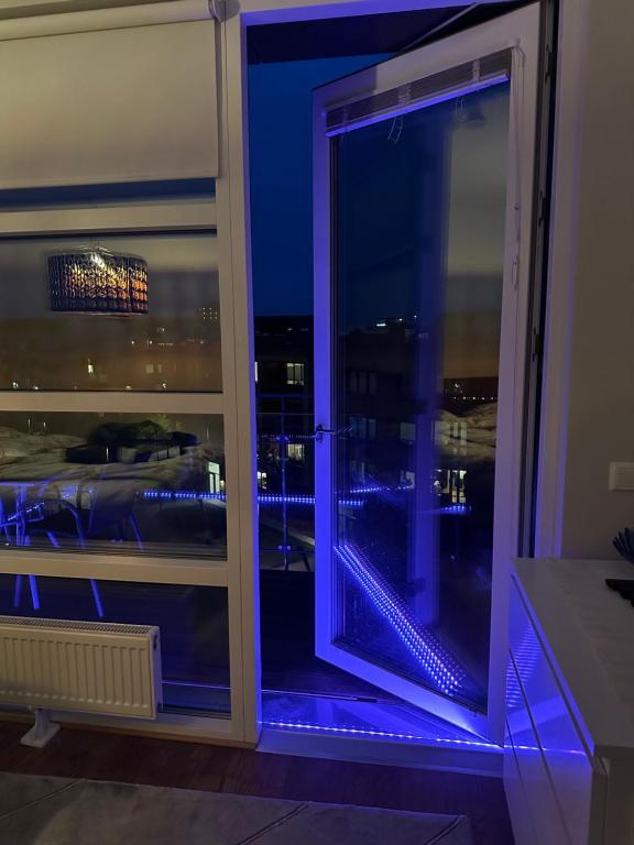 a window with a view of a city at night at Hyllie allé in Malmö