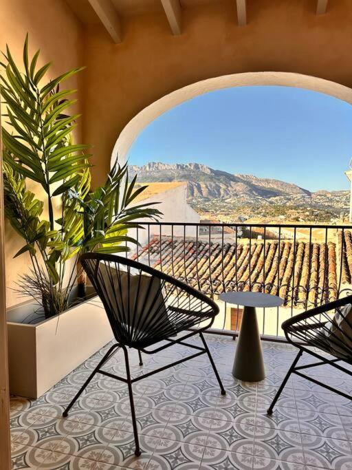 a patio with two chairs and a table on a balcony at Casa Casco Antiguo Altea - La Toalla in Altea