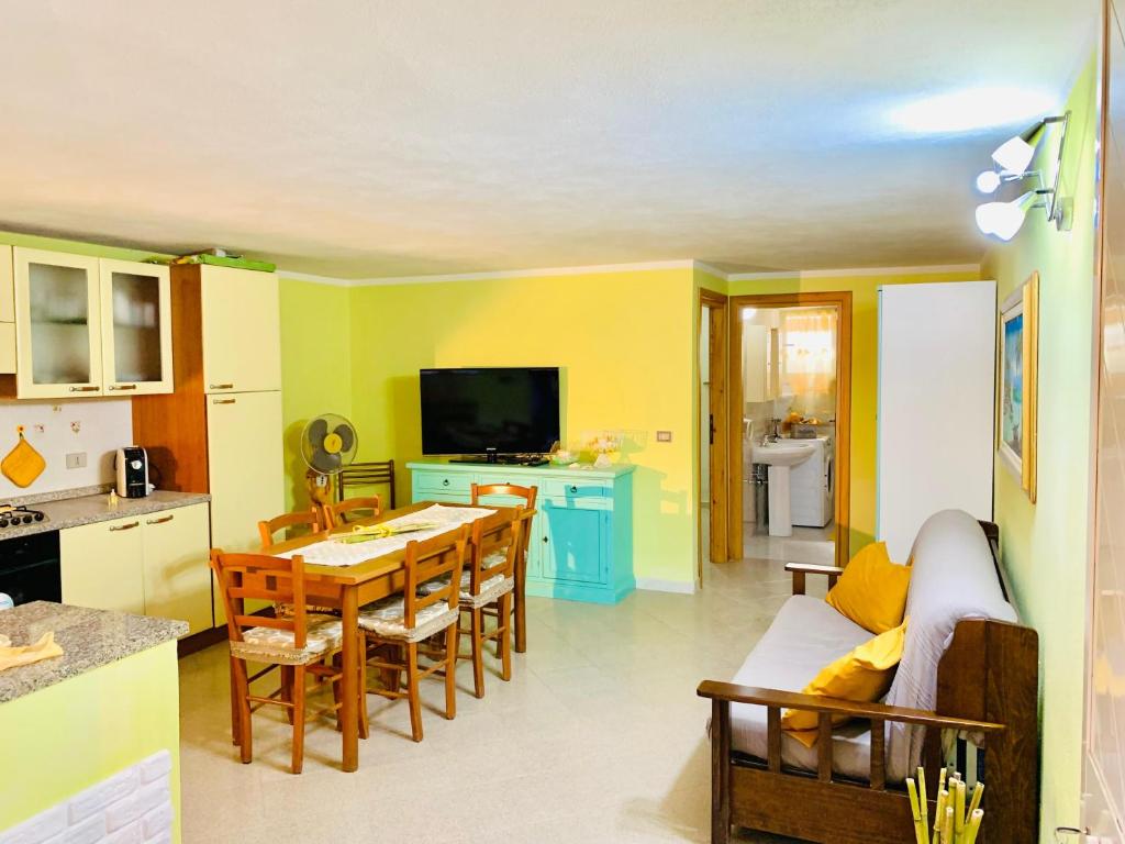 uma cozinha e sala de estar com uma mesa e uma sala de jantar em La maison en jaune em Limpiddu