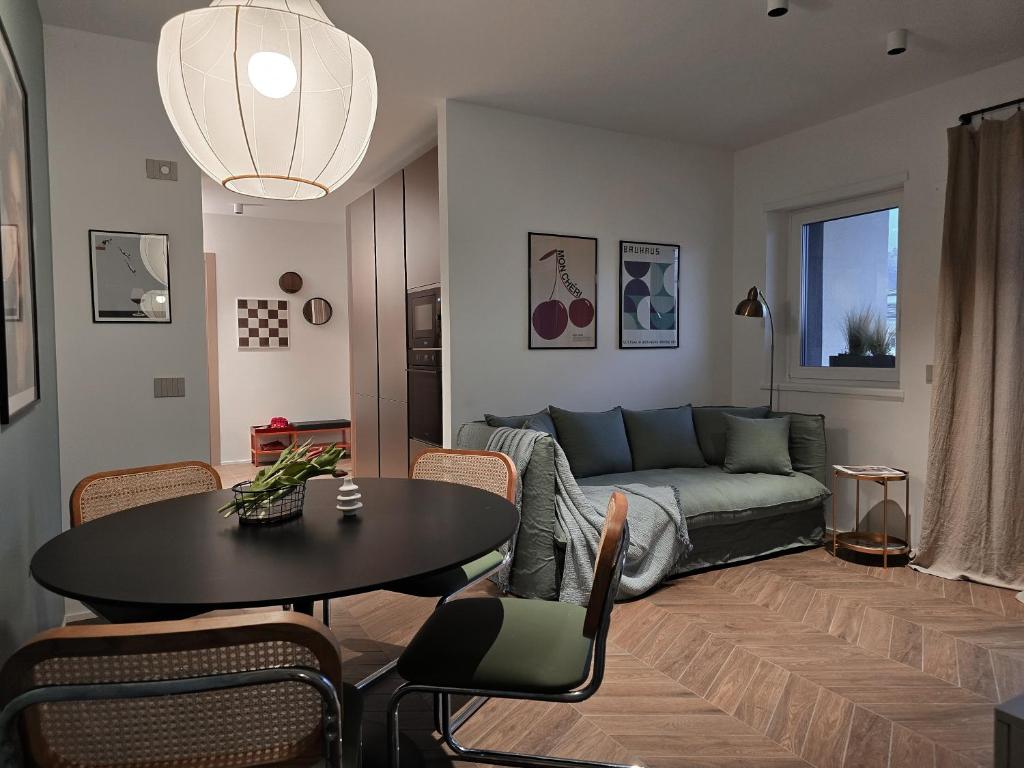 a living room with a couch and a table at Bolghera House in Trento