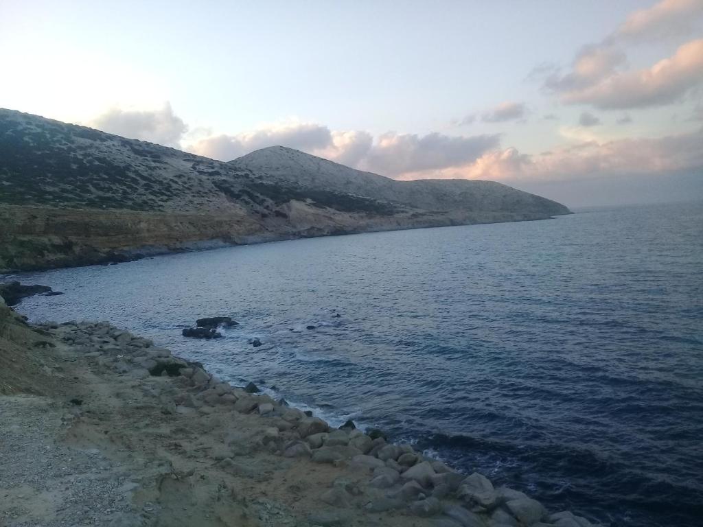 a view of a body of water with mountains in the background at les grottes de bizerte in Bizerte